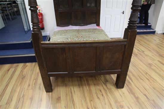 A 17th century carved oak tester bed, W.4ft 6in. H.6ft 1in. L.7ft 2in.
